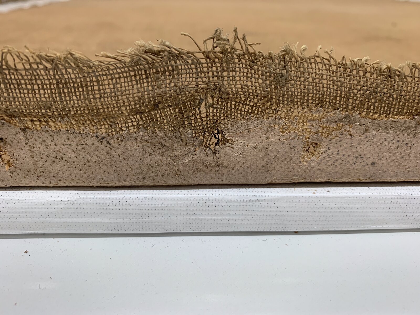 Close-up of a canvas edge along its wooden stretcher